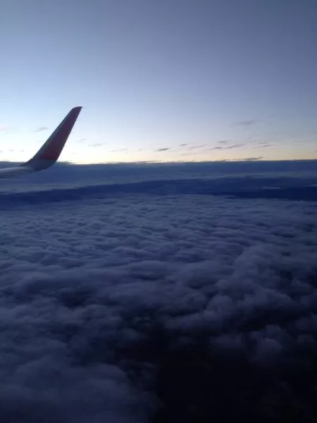 Blick aus einem Flugzeugfenster auf eine Woklkendecke